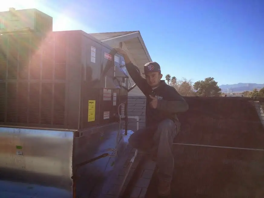 HVAC technician performing Air Duct Repair on a rooftop unit in Lake Arbor